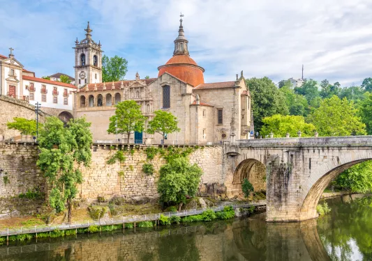 old stone buildings next to a river