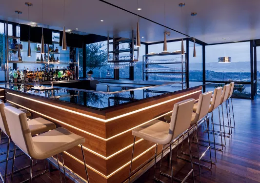 Indoor bar with white stools and marble counters
