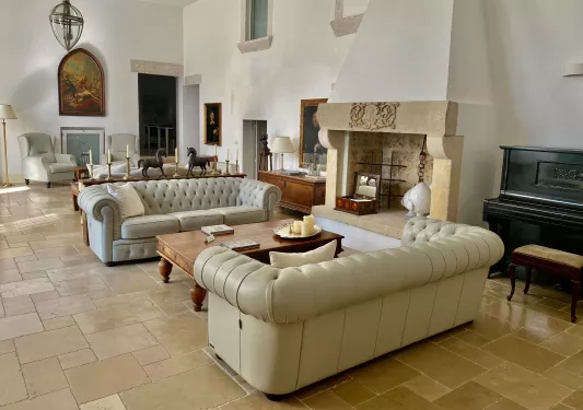white leather couches in living room with fireplace