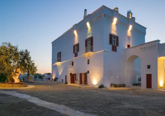 White stone building  with orange lights along the walls