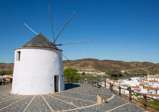 Rustic windmill tower overlooking a small town