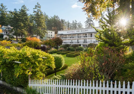 Hotel exterior, with a garden and white picket fence in front
