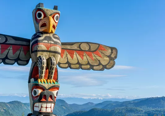 A wooden totem pole of different colorful animals