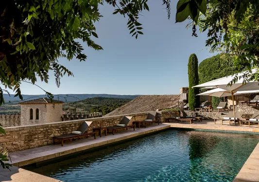 Rooftop pool with a view of stone buildings