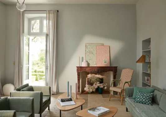 Indoor seating area with books on coffee tables and a door leading to an outdoor patio