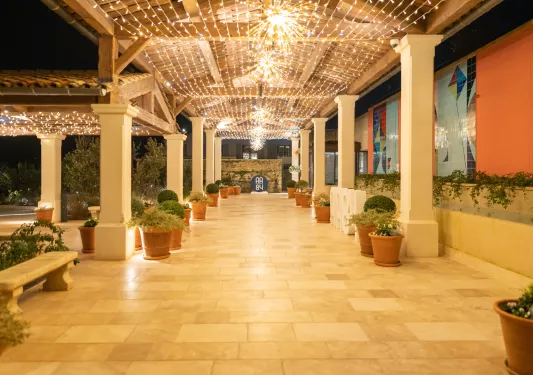 Stone outdoor walkway with string lights on the ceiling