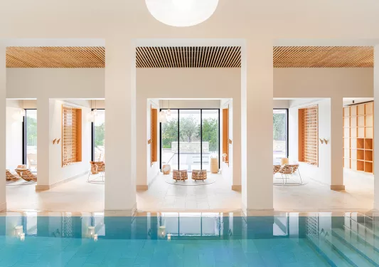 pool surrounded by tall columns