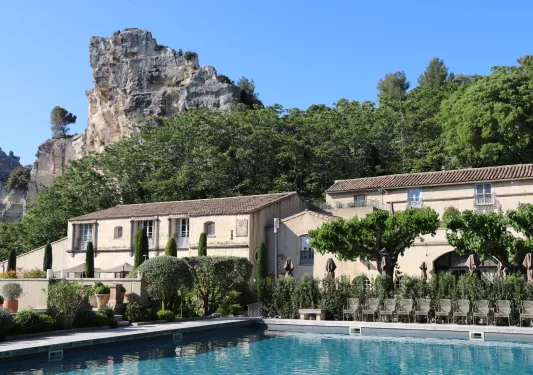 house and pool under rock formation