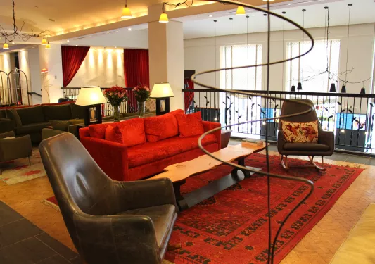 red couch and leather chairs in hotel living room