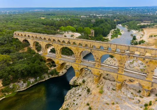 Rustic, stone bridge over a canyon and forest