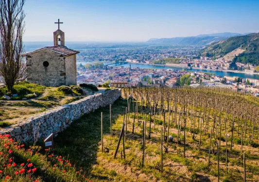 Church building on a hill looking down at a rustic town