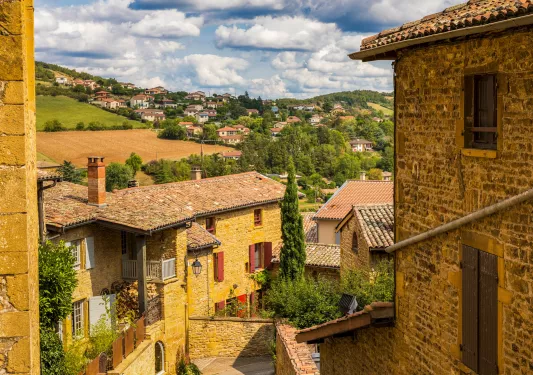 Alleyway between stone houses and a stairway leading down the path