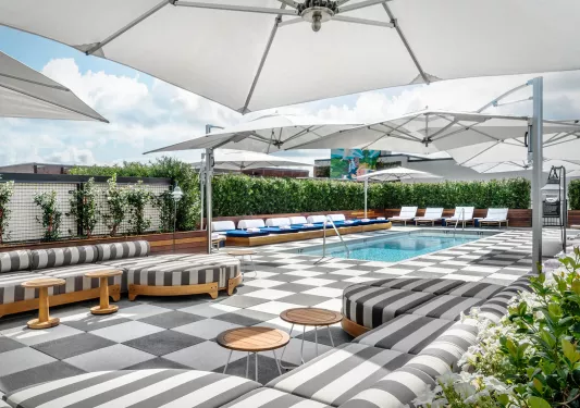 pool deck with lounge furniture and umbrellas