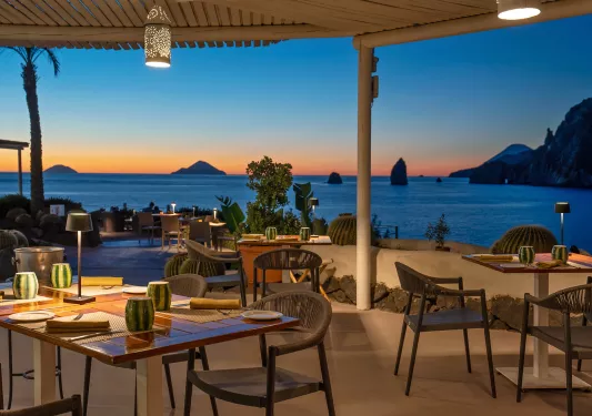 tables on patio overlooking sunset