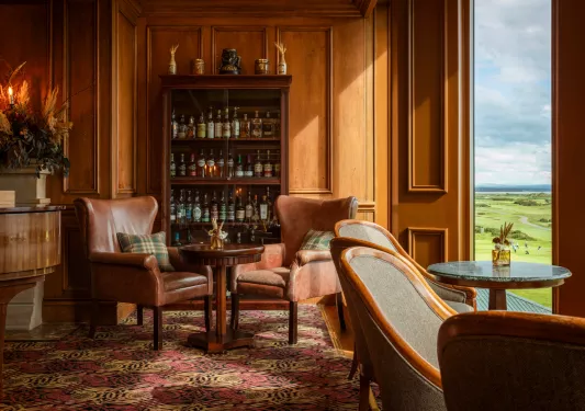sitting room with dark wood furniture and liquor cabinet