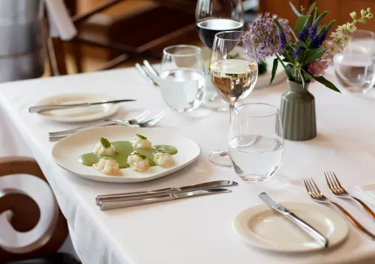 dining table set with plate and wine glass
