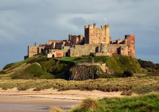 castle on a hill by a beach