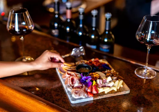 Charcuterie board covered with cured meats and fruits
