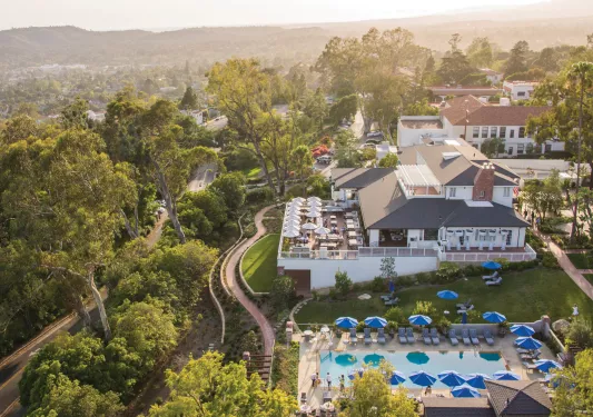 Top view of hotel with outdoor patio and an outdoor pool
