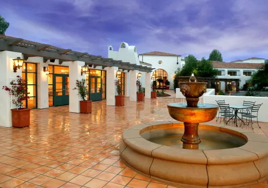 fountain in a plaza at sunset