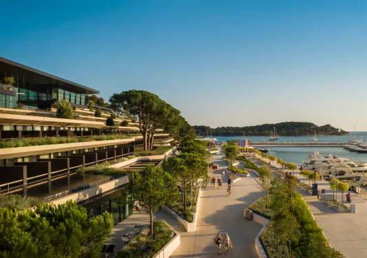 Hotel overlooking a boardwalk and water 
