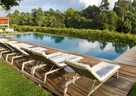 lounge chairs next to outdoor pool