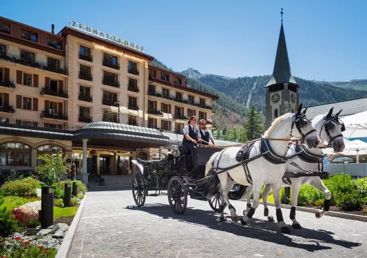horse drawn carriage out front of hotel zermatterhof