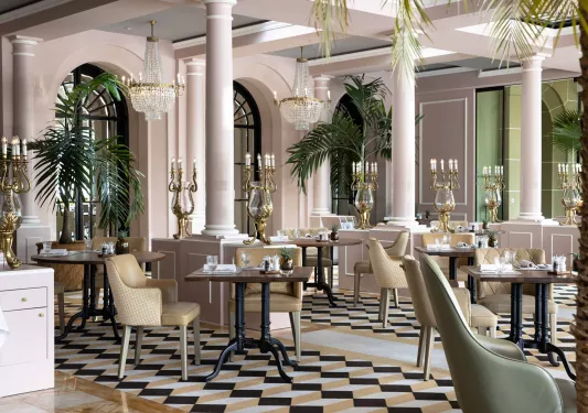 Indoor lounge and dining areas with pink walls and large pillars