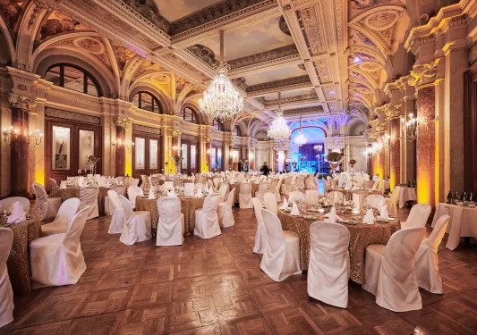 Banquet hall with circular tables and white chairs around each table
