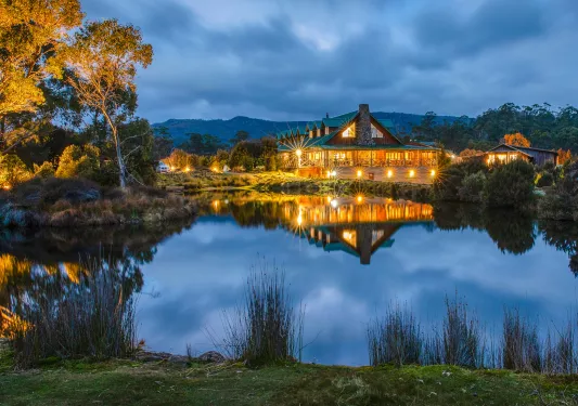hotel lit up at night across a lake