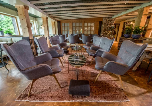 Indoor seating area and lounge with gray, cushioned chairs