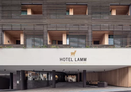 Outdoor view of a hotel sign with rooms and outdoor balconies