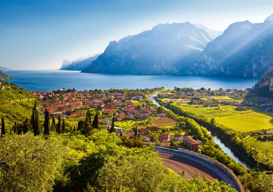 Small oceanside town with crop fields and mountains