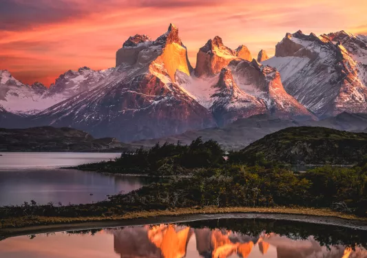 Sunset view of snow-capped mountains and multiple lakes