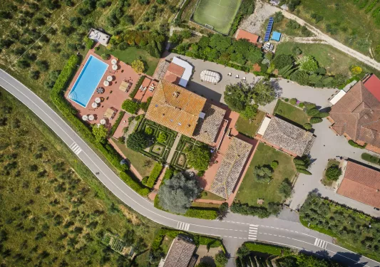 Sky view of hotel property, with an outdoor pool