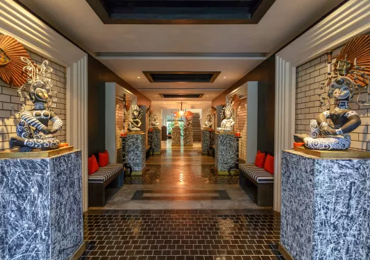 hallway decorated with columns and statues