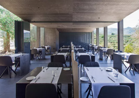tables in a hotel restaurant with glass walls