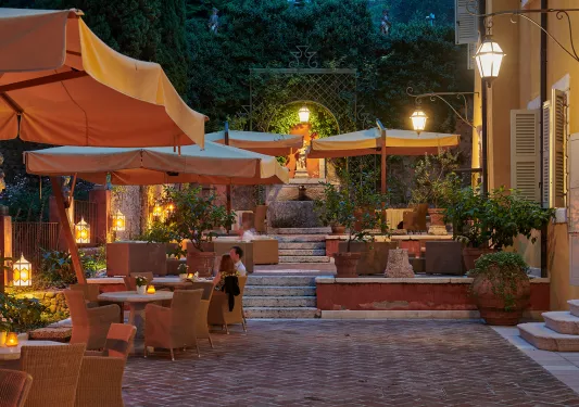Outdoor patio with chair and tables with a couple dining