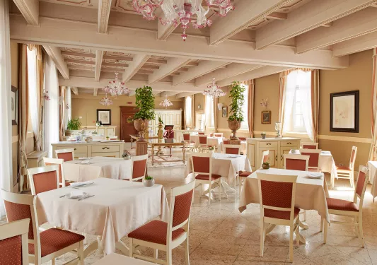 Indoor dining room with white tables and red chairs