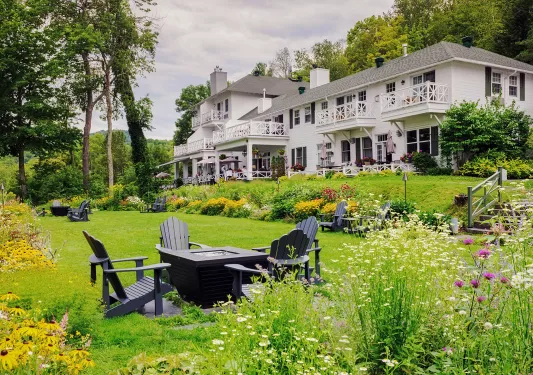 expansive lawn and fire pit outside of manor house