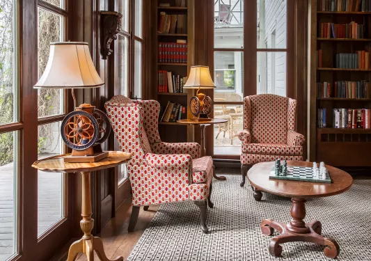 hotel library room with books and chairs