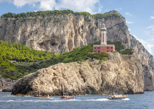 Light house on a rocky cliff by the ocean