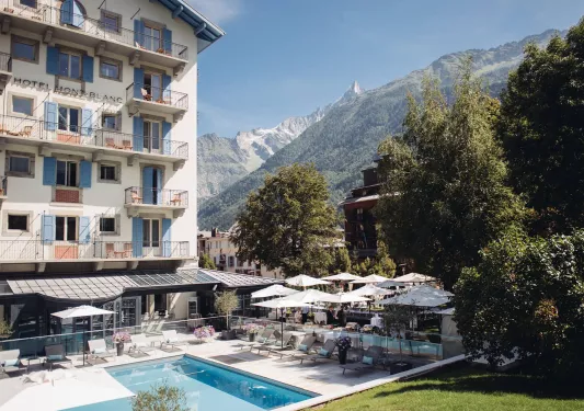 hotel and pool next to mountain