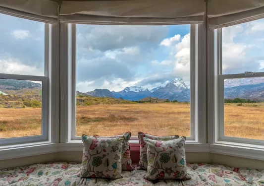 large bay windows looking onto mountains
