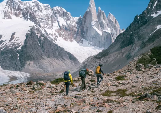 hikers walking against snowey mountains