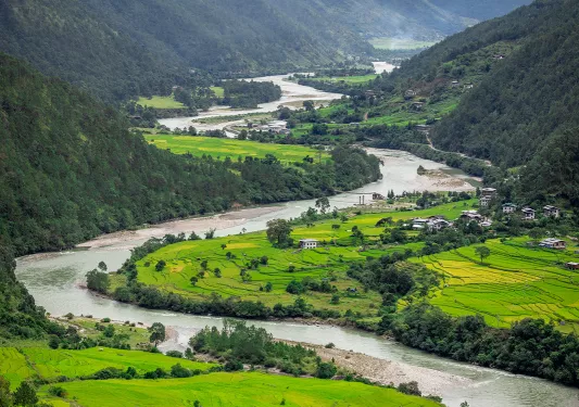 Large, grass valley with a river flowing through