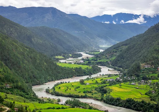Large grass field with a river cutting through