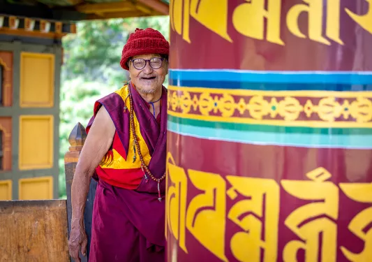 Man wearing a traditional robe while smile in a temple