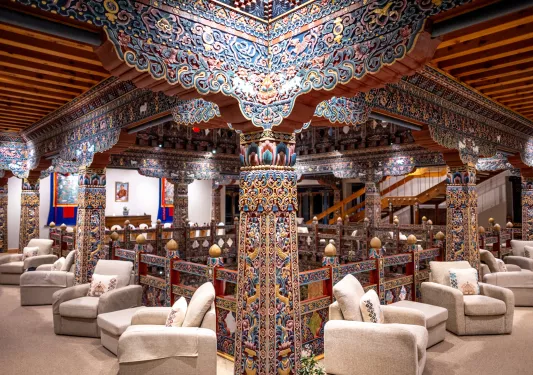 Second floor indoor lobby with cushioned chairs and traditional-style pillars
