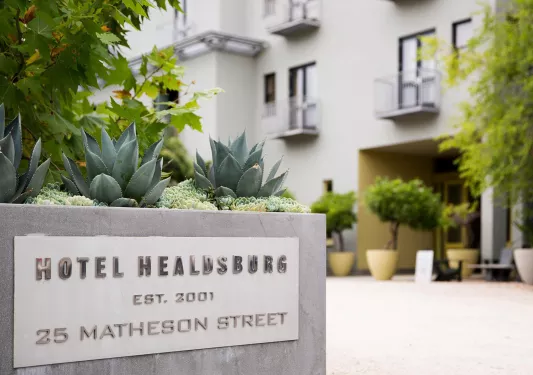 Stone hotel sign with cactus on top